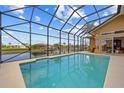 Screened-in pool area with scenic canal views, ideal for relaxation and outdoor entertainment at 1323 Mineo Dr, Punta Gorda, FL 33950