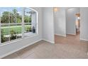 Bright living room with large windows offering scenic outdoor views and tile floor at 1762 Mincey Ter, North Port, FL 34286