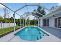 Beautiful screened in pool and patio area surrounded by lush landscaping at 1762 Mincey Ter, North Port, FL 34286