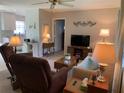 Cozy living room featuring comfortable seating and an open layout with views to the kitchen at 18094 Ackerman Ave, Port Charlotte, FL 33948