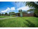 Inviting single-story home showcases a well-kept yard, secure fencing, and an attached garage, perfect for comfortable living at 21539 Gladis Ave, Port Charlotte, FL 33952