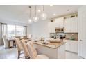 Bright kitchen with white cabinets, granite countertops, and stainless steel appliances at 2308 Oberon Ln, Punta Gorda, FL 33983