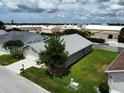Aerial view of a home featuring a well-manicured lawn and an attached two-car garage at 24132 Buckingham Way, Punta Gorda, FL 33980