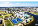 Stunning aerial view of community amenities including a pool, tennis courts, and a clubhouse at 24132 Buckingham Way, Punta Gorda, FL 33980