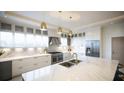 Bright kitchen features marble countertops, stainless steel appliances, and modern fixtures at 24317 Treasure Island Blvd, Punta Gorda, FL 33955