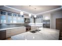 Modern kitchen featuring marble countertops, stainless steel appliances, and custom cabinetry at 24317 Treasure Island Blvd, Punta Gorda, FL 33955