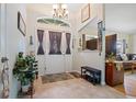 Welcoming home foyer featuring neutral tile flooring and decorative elements at 2455 Jacoby Cir, North Port, FL 34288