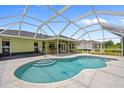 Inviting backyard pool with a screened enclosure, perfect for outdoor relaxation and entertainment at 2455 Jacoby Cir, North Port, FL 34288