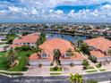 A beautiful townhome with tropical landscaping and a tranquil waterfront view from an aerial perspective at 2630 Tarpon Cove Dr # 211, Punta Gorda, FL 33950