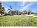 Attractive house with landscaped yard, a brick driveway, and a two-car garage at 27896 Arrowhead Cir, Punta Gorda, FL 33982