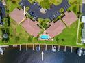 Aerial view showcasing the condo's pool, boat docks, and waterfront access at 3221 White Ibis Ct # D1, Punta Gorda, FL 33950