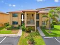 Inviting condo exterior with well-maintained landscaping and convenient parking at 3221 White Ibis Ct # D1, Punta Gorda, FL 33950