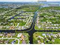 Aerial view of a waterfront community showing canal access to Charlotte Harbor and a public boat ramp at 4123 Rock Creek Dr, Port Charlotte, FL 33948