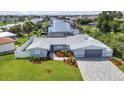 Aerial view of the property showcasing the backyard, canal, surrounding community and waterway access at 4244 Harbor Blvd, Port Charlotte, FL 33952