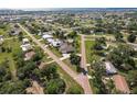 Aerial view of a home nestled among lush greenery in a quiet neighborhood near the water at 437 South Dr, Punta Gorda, FL 33950