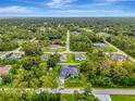 Aerial view of a lovely property surrounded by lush greenery and trees, blending privacy and nature at 6444 Alhambra Ave, North Port, FL 34291