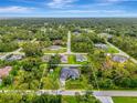 Aerial view of home surrounded by lush trees, showcasing its property lines at 6444 Alhambra Ave, North Port, FL 34291