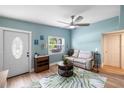 Cozy living room with a front door, shoe rack, ceiling fan and a leaf-patterned rug at 1027 Coral Ridge Dr, Punta Gorda, FL 33950