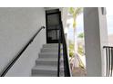 Condominium stairwell with handrail leading to the unit entrance at 12390 Wellen Golf St # 202, Venice, FL 34293
