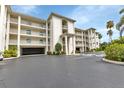 Stylish condo building showcasing covered parking, multiple stories with elegant balconies, and well-maintained landscaping at 1250 W Marion Ave # 333, Punta Gorda, FL 33950