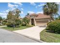 Well-maintained home showcasing a spacious driveway, two-car garage, and manicured shrubs at 13139 Preserve Ct, Port Charlotte, FL 33953