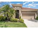 Inviting home with a two-car garage, elegant entryway, and well-maintained front yard at 13139 Preserve Ct, Port Charlotte, FL 33953