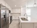 Beautiful bright kitchen featuring white cabinets, granite countertops, and stainless steel appliances at 14141 Heritage Landing Blvd # 921, Punta Gorda, FL 33955