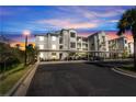 Beautiful multi-story condominium building with assigned covered parking spaces during a colorful sunset at 14161 Heritage Landing Blvd # 1122, Punta Gorda, FL 33955