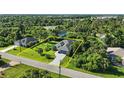 Aerial view of a single-Gathering home surrounded by lush greenery, showcasing its location at 149 Crevalle Rd, Rotonda West, FL 33947