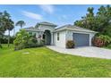 Charming single-story home with a two-car garage, brick driveway, and well-maintained landscaping at 149 Crevalle Rd, Rotonda West, FL 33947