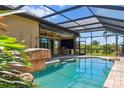 Inviting screened-in pool area featuring a built-in grill, perfect for outdoor entertaining and relaxation at 170 Antilla Dr, Rotonda West, FL 33947