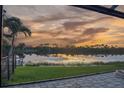 Relaxing water view from the screened lanai with the beautiful sunset reflecting on the still lake at 170 Antilla Dr, Rotonda West, FL 33947