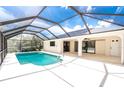 Relax in the spacious screened-in pool area, with a sparkling pool and ample space for outdoor lounging at 18147 Brazil Ave, Port Charlotte, FL 33948