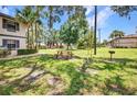 Grassy common area featuring a picnic table and charcoal grill at 19505 Quesada Ave # Tt101, Port Charlotte, FL 33948