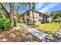 Exterior of the condo with well-manicured lawn and tropical landscaping at 19505 Quesada Ave # Tt101, Port Charlotte, FL 33948