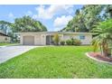 Inviting single-story home featuring a well-maintained lawn and attached garage at 2131 Amanda Dr, Sarasota, FL 34232