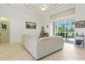 Bright living room with tile floors, high ceiling and large windows leading to the outdoor patio area at 2329 Como St, Port Charlotte, FL 33948