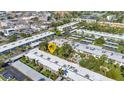 Birds eye view of the complex with surrounding buildings, landscaping and a nearby parking area at 2437 Harbor Blvd # 114, Port Charlotte, FL 33952