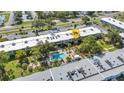 An aerial of the complex, displaying a shared community pool, lush landscaping and parking at 2437 Harbor Blvd # 114, Port Charlotte, FL 33952