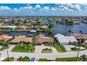 An aerial view of a single-Gathering home with waterfront access and mature landscaping at 2814 La Mancha Ct, Punta Gorda, FL 33950