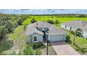 Stylish single-Gathering home with brick paver driveway with a backdrop of green space at 3631 Pebble Ter, Punta Gorda, FL 33980