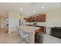 A kitchen featuring stainless steel appliances, granite counters, and a center island with seating at 3631 Pebble Ter, Punta Gorda, FL 33980