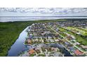 Beautiful aerial view of a waterfront community with lush landscaping, boat docks, and stunning views at 3800 Carupano Ct, Punta Gorda, FL 33950