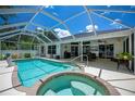Relaxing screened-in pool and spa with a spacious patio for outdoor entertaining at 3824 Dominic St, North Port, FL 34288