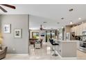 Bright, open kitchen with stainless steel appliances, a kitchen island, and pendant lighting at 4180 Lenox Blvd, Venice, FL 34293
