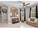 Comfortable living room featuring neutral decor, a large window, and plenty of natural light at 4180 Lenox Blvd, Venice, FL 34293