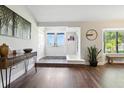 Inviting foyer featuring hardwood floors, a modern console table, and ample natural light at 5052 Kingsley Rd, North Port, FL 34287