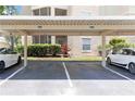 Assigned carport parking featuring reserved parking spaces and landscaping at 5146 Northridge Rd # 305, Sarasota, FL 34238