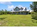 Beautiful home with a large front yard and a classic covered porch, perfect for relaxing at 5242 Blackjack Cir, Punta Gorda, FL 33982