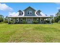 Charming home with a large yard, inviting front porch, and beautiful architectural details at 5242 Blackjack Cir, Punta Gorda, FL 33982